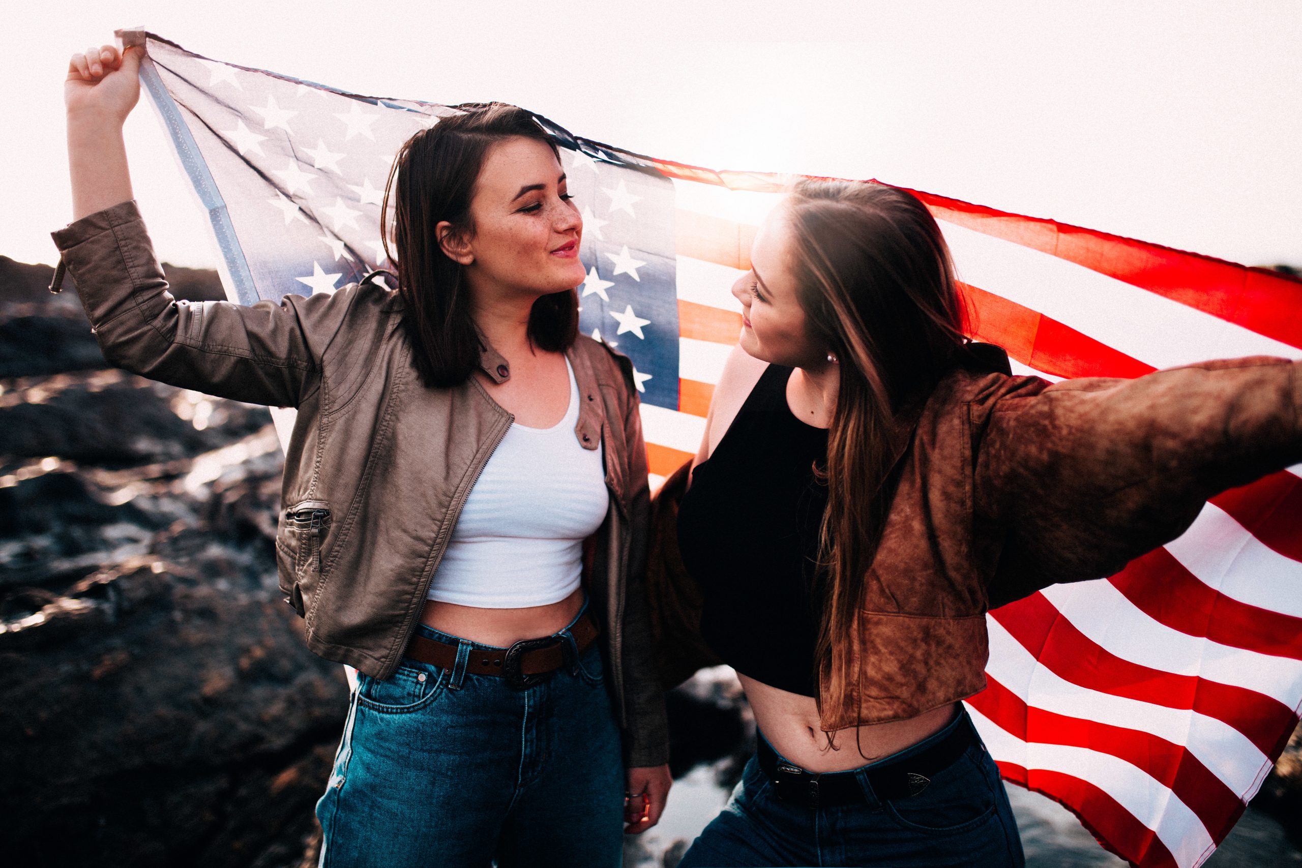 Expert Removals Two young women holding an american flag.